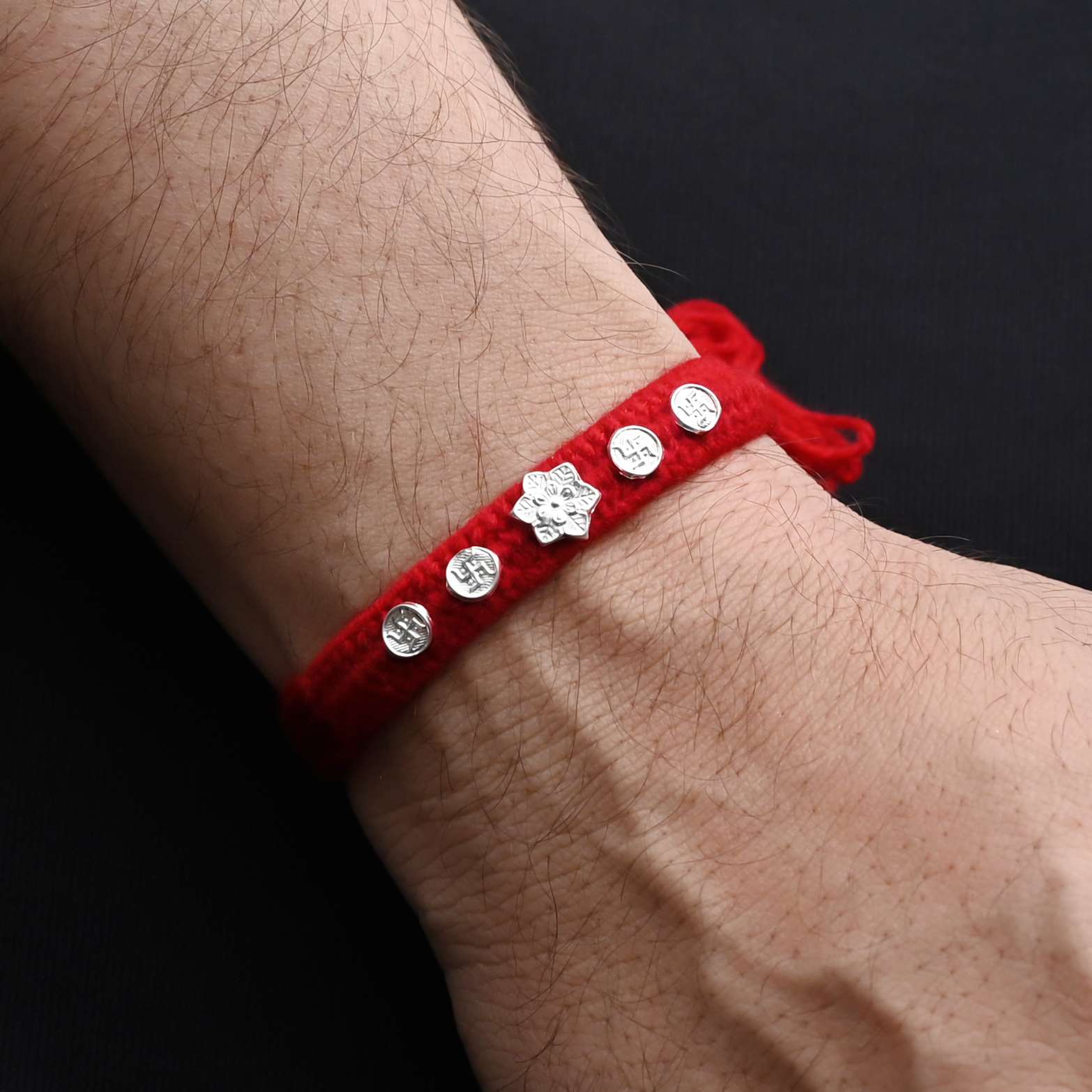 Elegant silver flower with Swasthik symbol, ideal Rakhi for boys