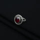 Stylish silver ring showcasing round maroon stone.