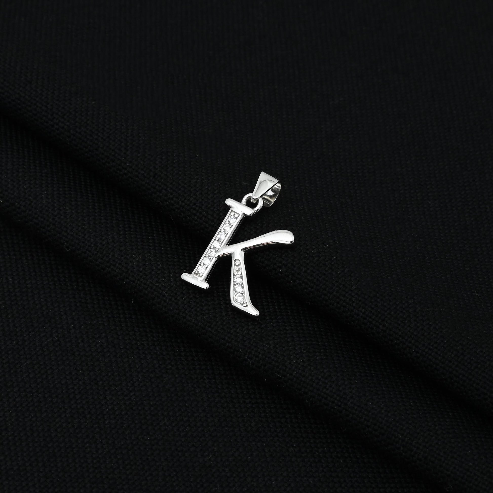 Sleek and modern silver pendant showcasing the letter 'K' in a unique design