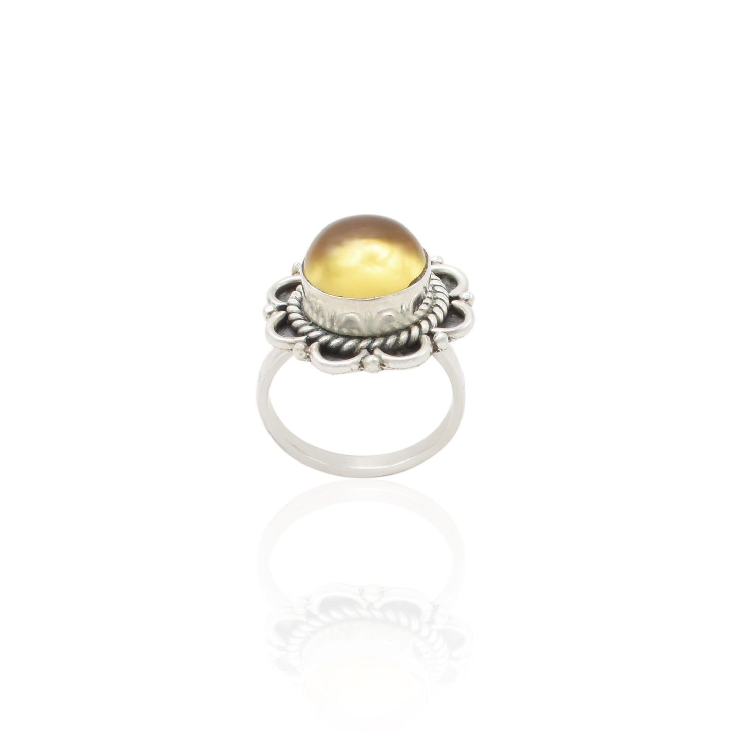 Close-up of a silver ring with a stunning golden gemstone, designed to add a touch of luxury and sophistication.