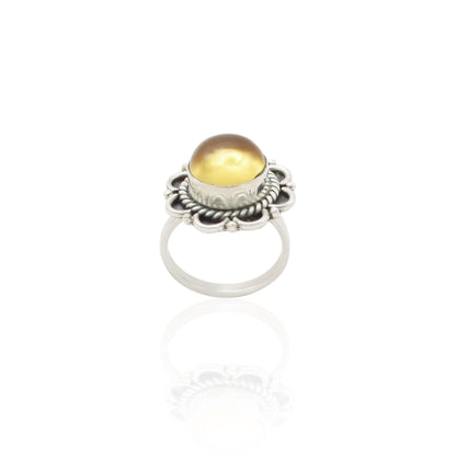 Close-up of a silver ring with a stunning golden gemstone, designed to add a touch of luxury and sophistication.