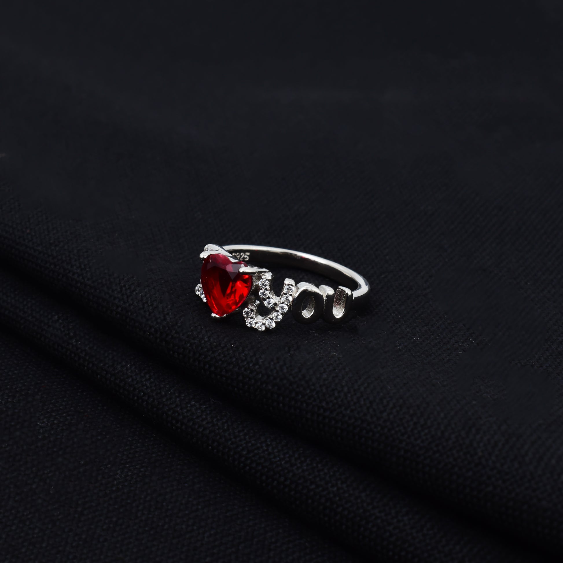 Romantic silver ring featuring red heart design.