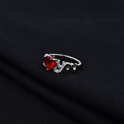 Romantic silver ring featuring red heart design.