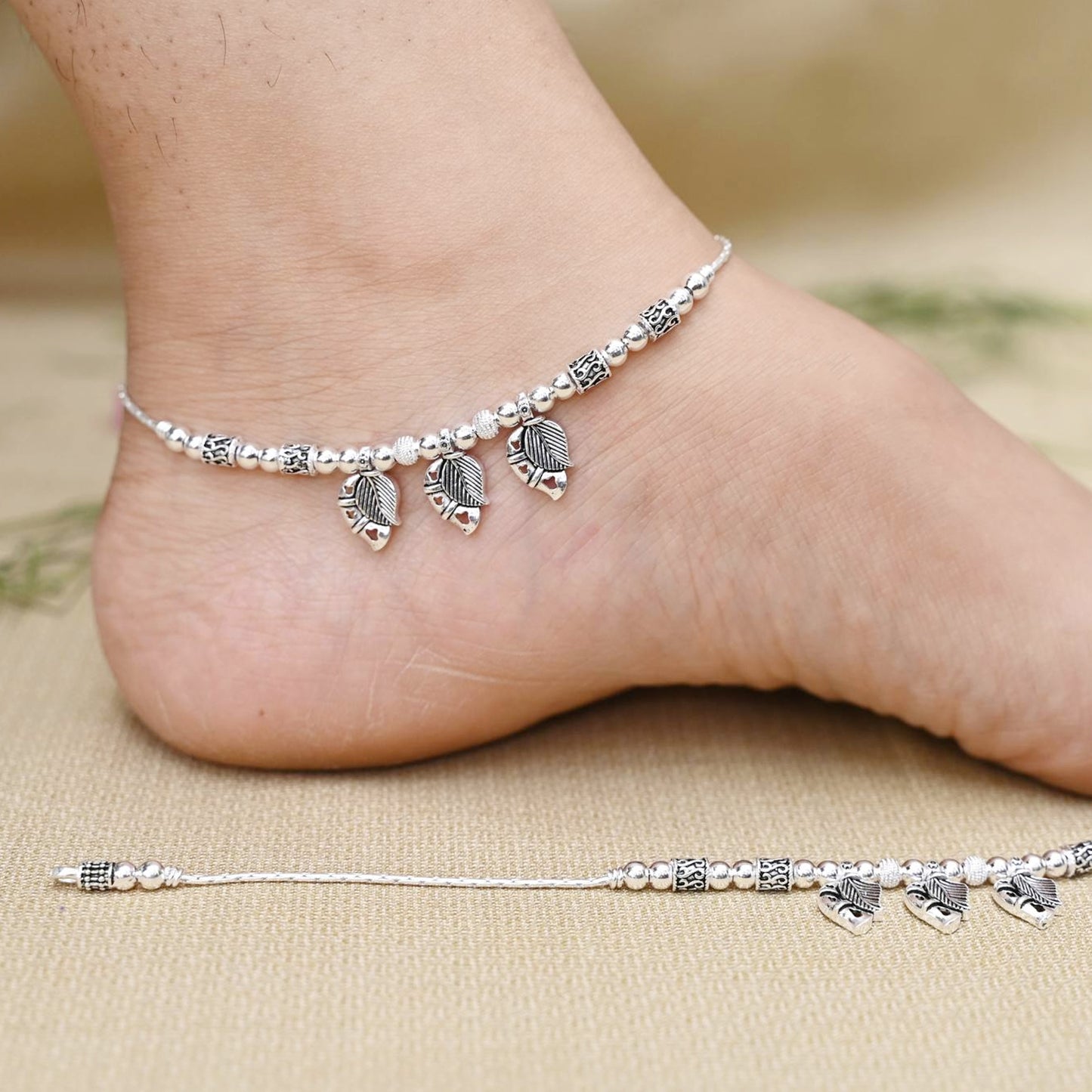 Unique design silver payal with a leaf motif and delicate beads