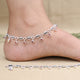 Elegant silver anklet featuring delicate shell-shaped charms.