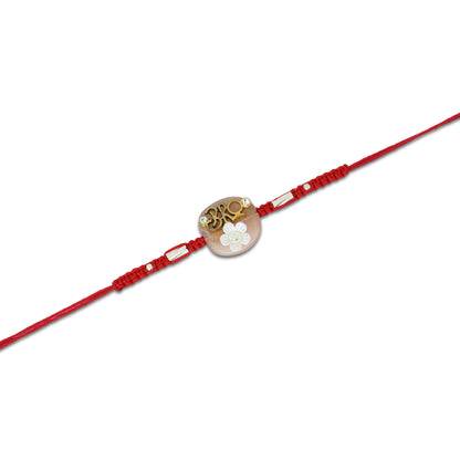 Boys' Rakhi featuring a silver 'Bro' centerpiece with a delicate white flower accent