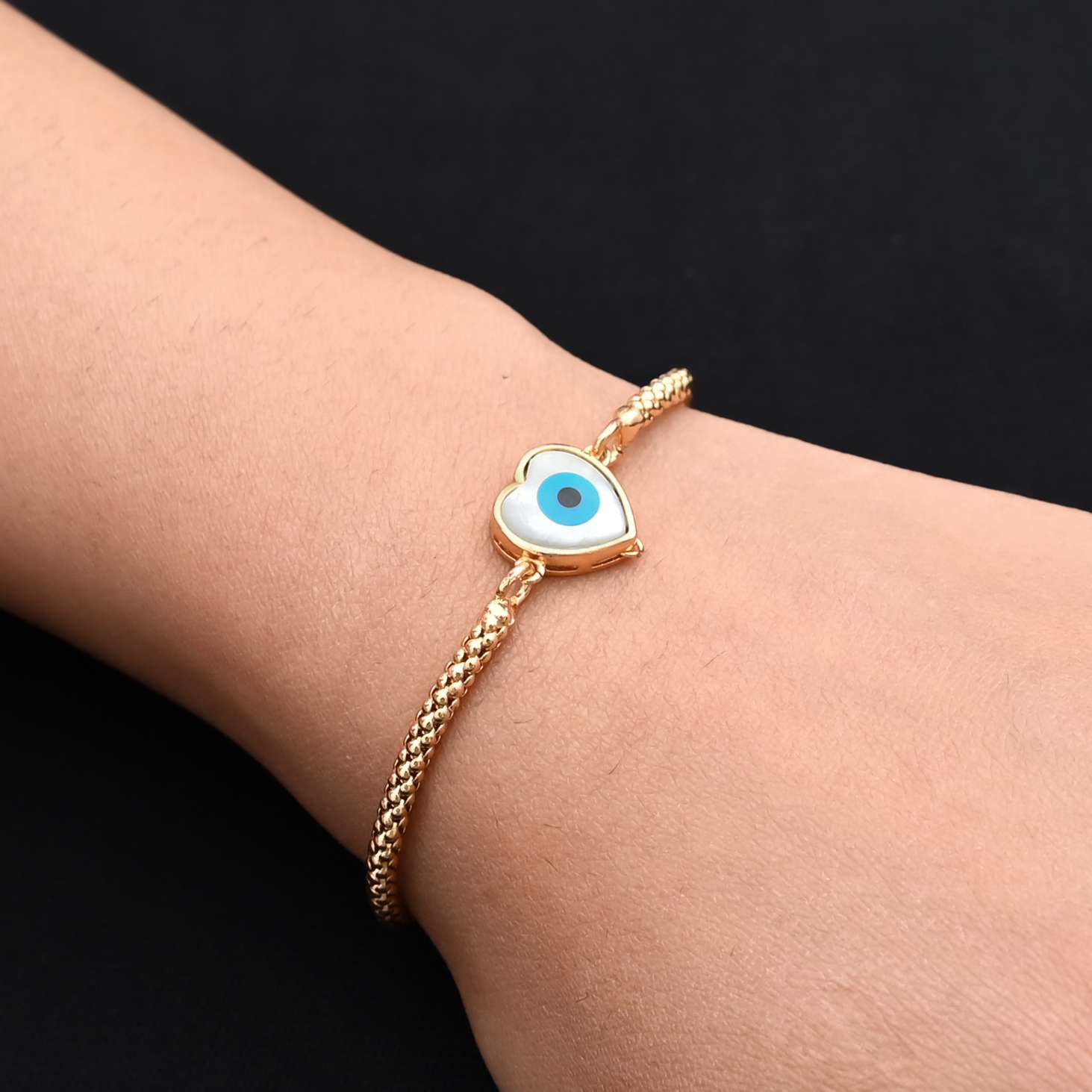 Trendy sterling silver bracelet for girls with a unique evil eye design inside a heart