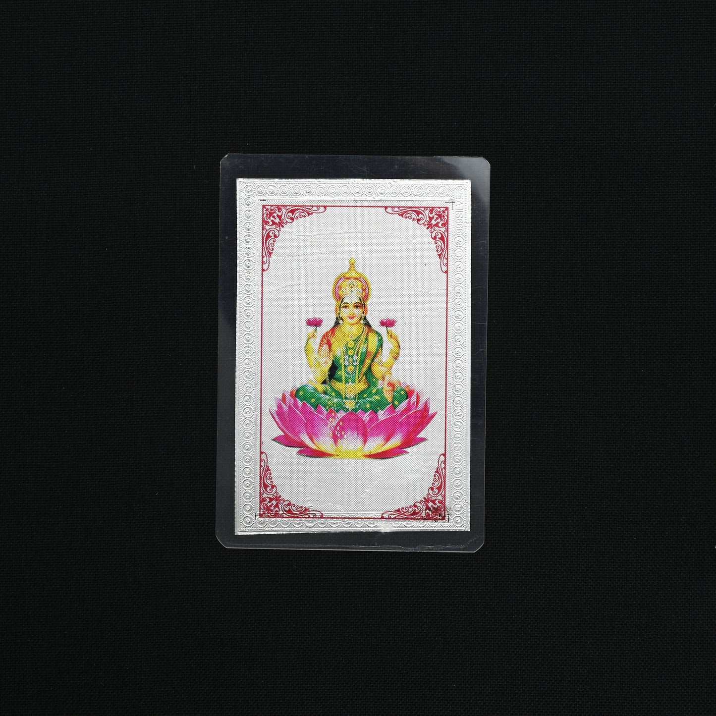 Close-up of the 999 silver Lucky Lakshmi Ji Yantra picture card, featuring intricate designs for wealth.