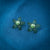 Charming green flower-shaped stud earrings with pearl center in sterling silver