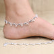 Ethnic silver anklet featuring charming shell-shaped accents.