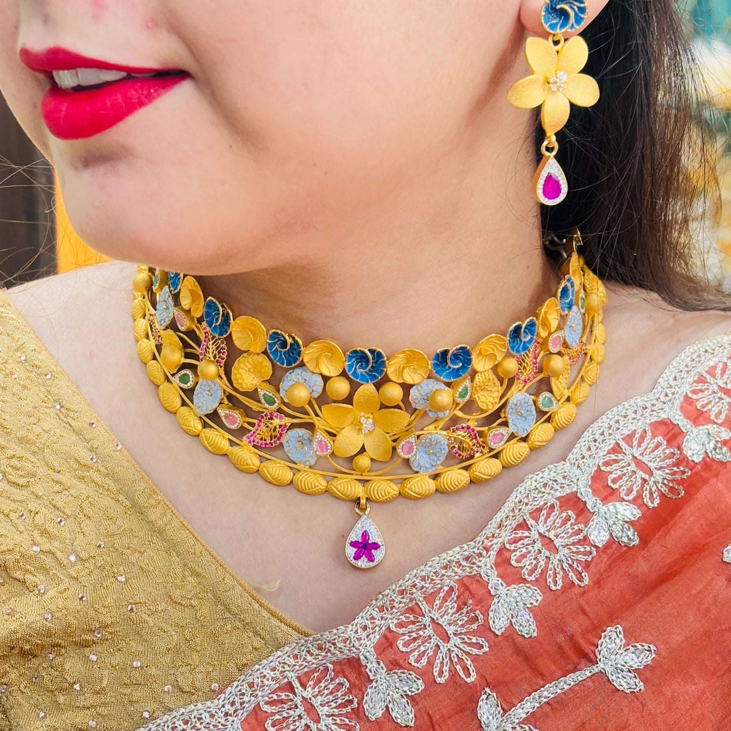 Timeless Beauty Gold Polish Silver Necklace with Gold Flower Center, Colorful Stones, and Leaf Accents.