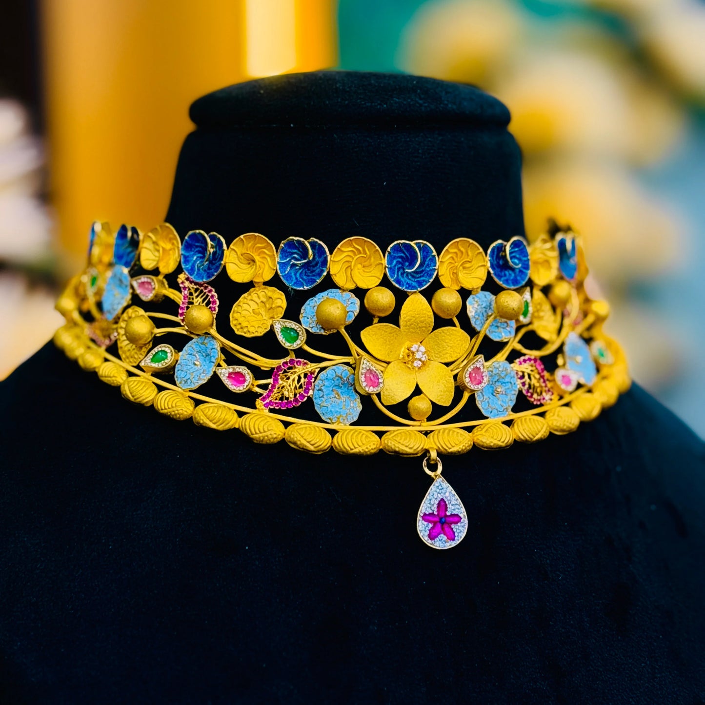 Timeless Beauty Gold Polish Silver Necklace with Gold Flower Center, Colorful Stones, and Leaf Accents.