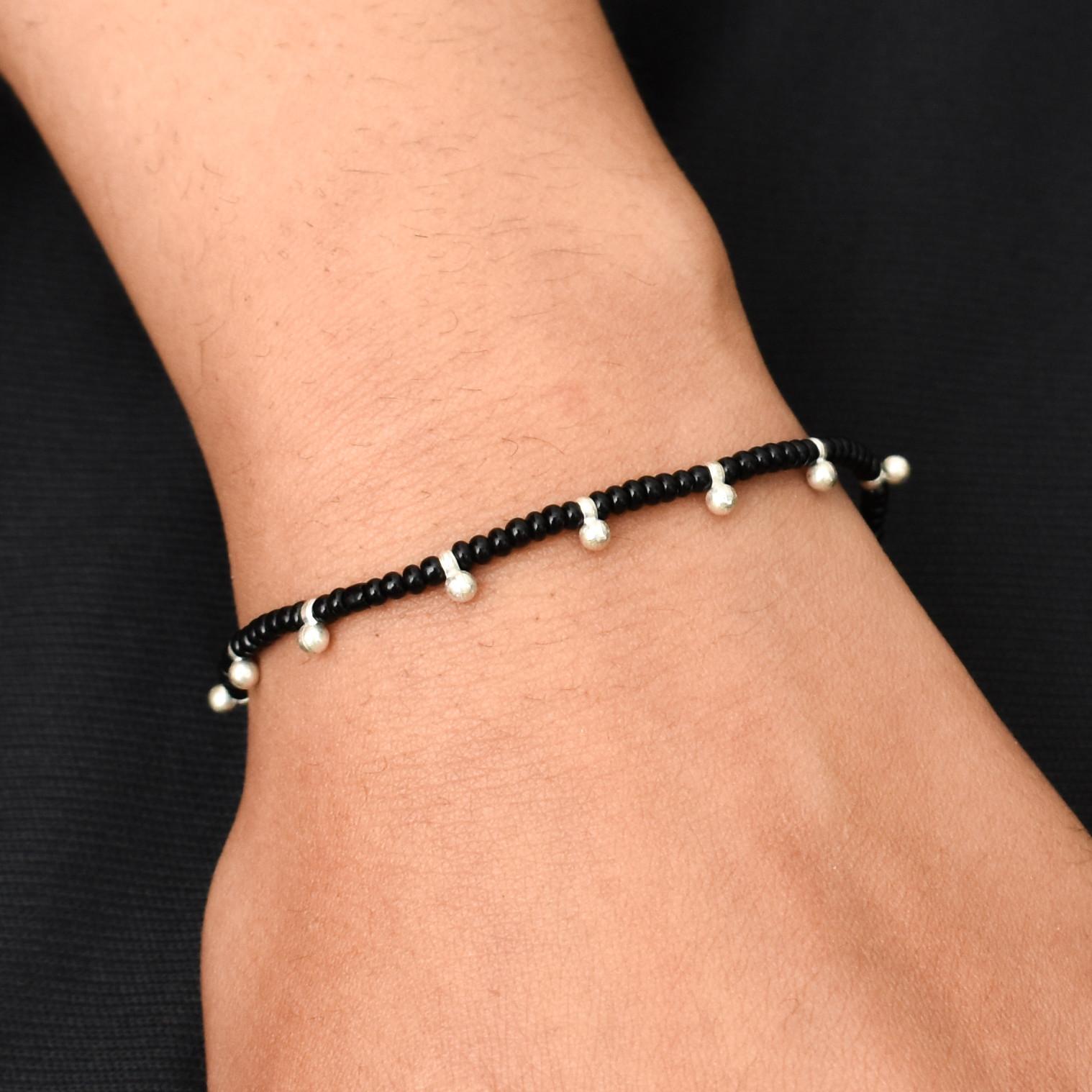 Elegant dhaga bracelet featuring a blend of silver and black beads for a traditional yet modern design.