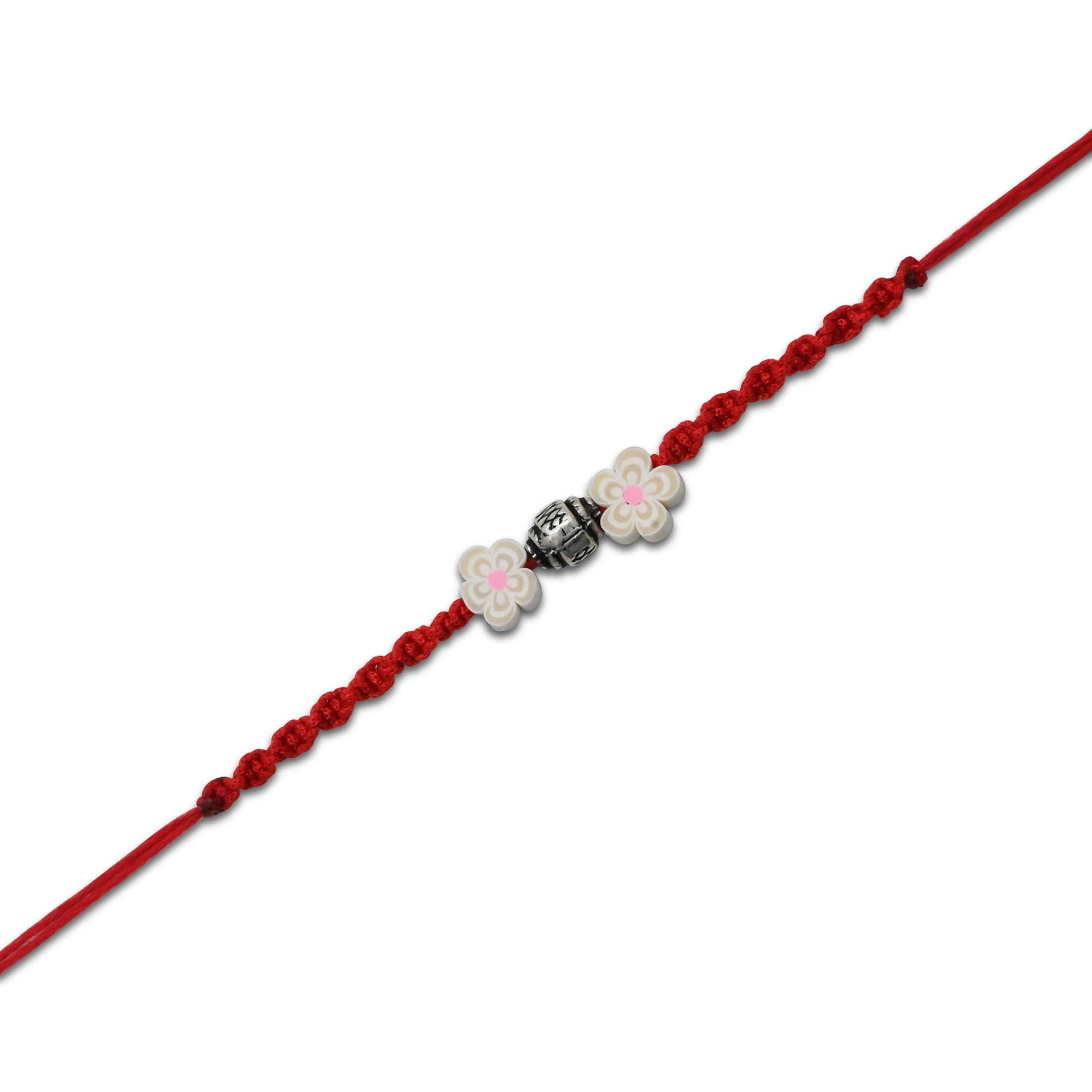 Boys' Rakhi featuring a silver bead centerpiece and two elegant cream-colored flowers.