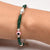 Silver bracelet for girls featuring a pink evil eye charm with silver and green beads