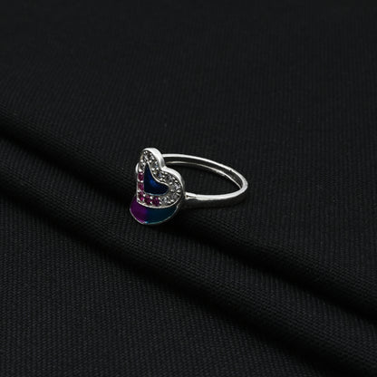 Stylish silver ring showcasing a vibrant blue heart stone, offering a glamorous and timeless accessory.