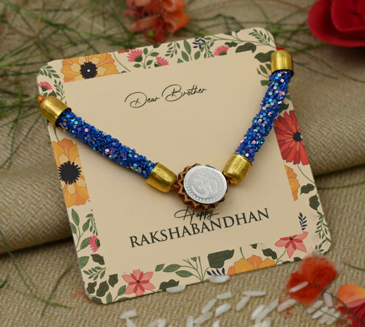 Silver center Om design with blue flat circular plastic beads, perfect Rakhi for boys.