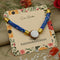 Silver Center Om with Blue Flat Circular Plastic Beads Rakhi for Boys