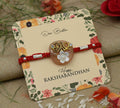 Silver center 'Bro' design with a white flower, perfect Rakhi for boys.