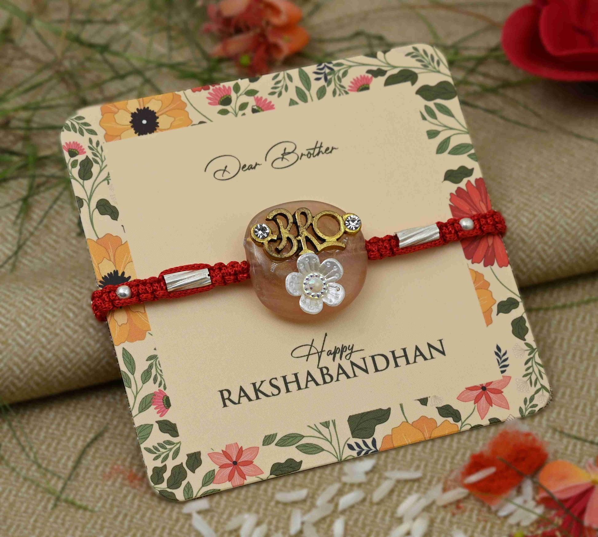 Silver center 'Bro' design with a white flower, perfect Rakhi for boys.