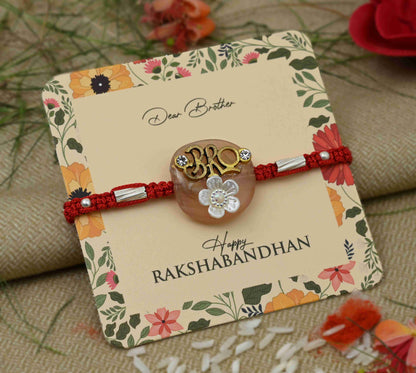 Silver center 'Bro' design with a white flower, perfect Rakhi for boys.