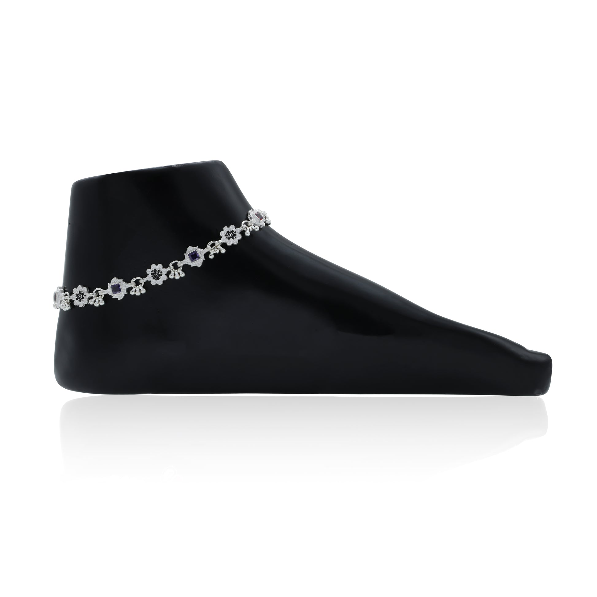 Elegant silver anklet featuring ghungroo accents and dazzling gemstones