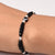 Sterling silver bracelet for girls featuring a black evil eye charm and black beads