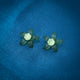 Charming green flower-shaped stud earrings crafted in sterling silver