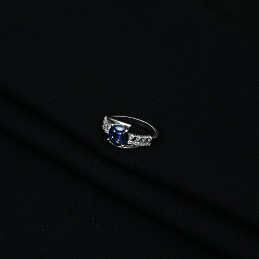 Elegant Silver Ring with Blue Stone and White Stone Detail.