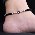 Silver payal featuring evil eye and gold beads.