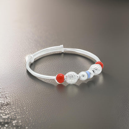 Charming sterling silver baby kada featuring a mix of orange and silver beads