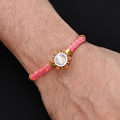 Traditional Rakhi for boys with silver Baal Gopal and pink flat circular beads