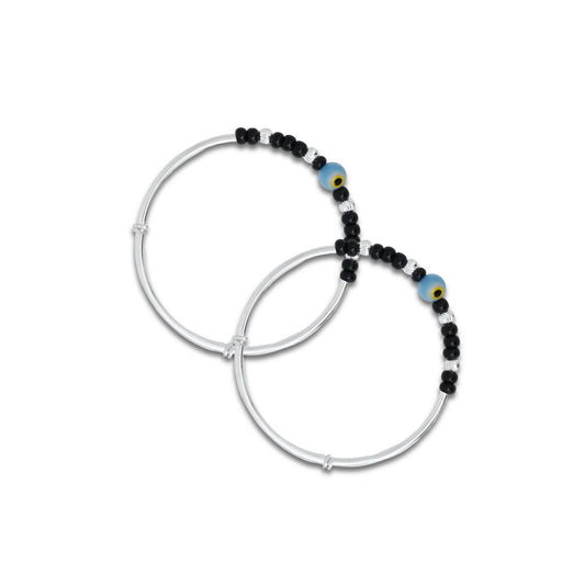 Baby silver kada payal featuring a center blue and yellow evil eye with black and silver beads.