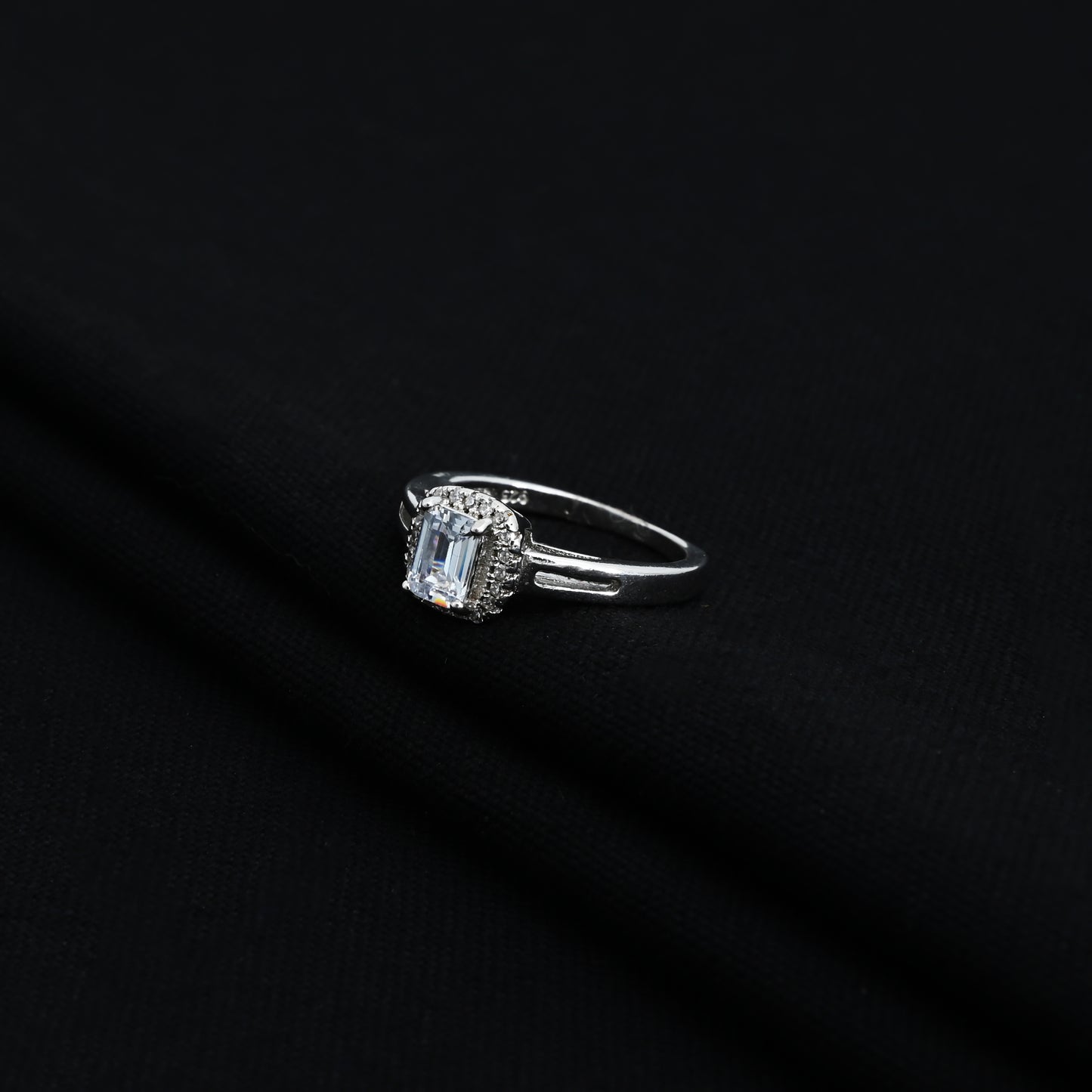 Stylish silver ring with rectangular blue stone and CZ accents.