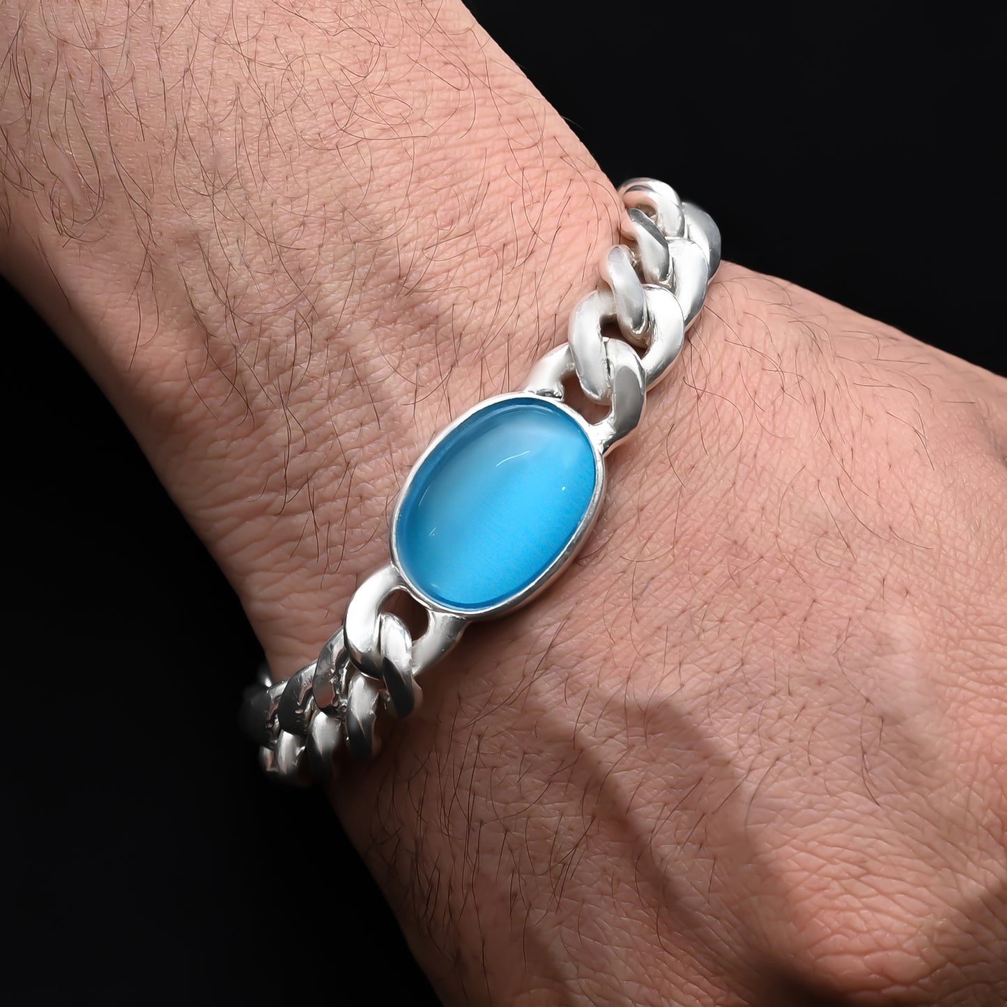 Men's silver chain bracelet with a bold center blue stone