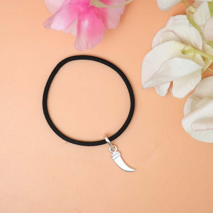 A trendy bracelet with a gleaming silver charm