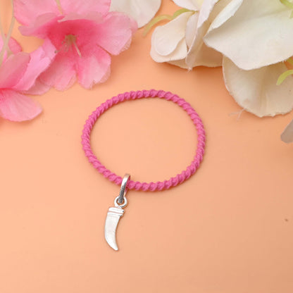 A trendy bracelet with a gleaming silver charm