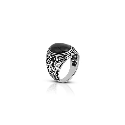 Elegant silver ring featuring a traditional design and oval black gemstone