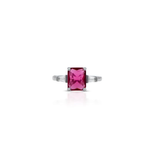 Sterling silver ring featuring a vibrant pink gemstone on a polished band.