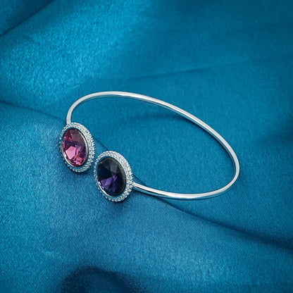 Elegant sterling silver kada adorned with vibrant royal blue and pink gems