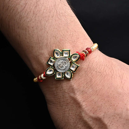 Elegant Rakhi with a silver Om flower design and colorful beads, ideal for boys