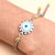 Elegant silver bracelet featuring a protective evil eye charm