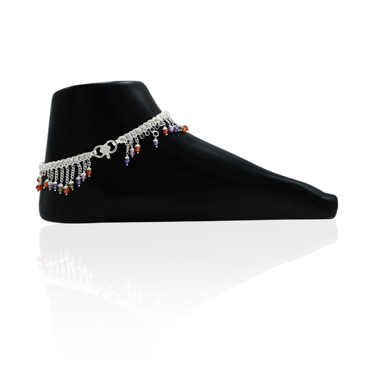 Elegant silver anklet adorned with colorful gems in an up-and-down pattern for a playful touch