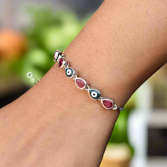 Stylish silver bracelet featuring alternative pink and evil eye gems for a striking, modern look