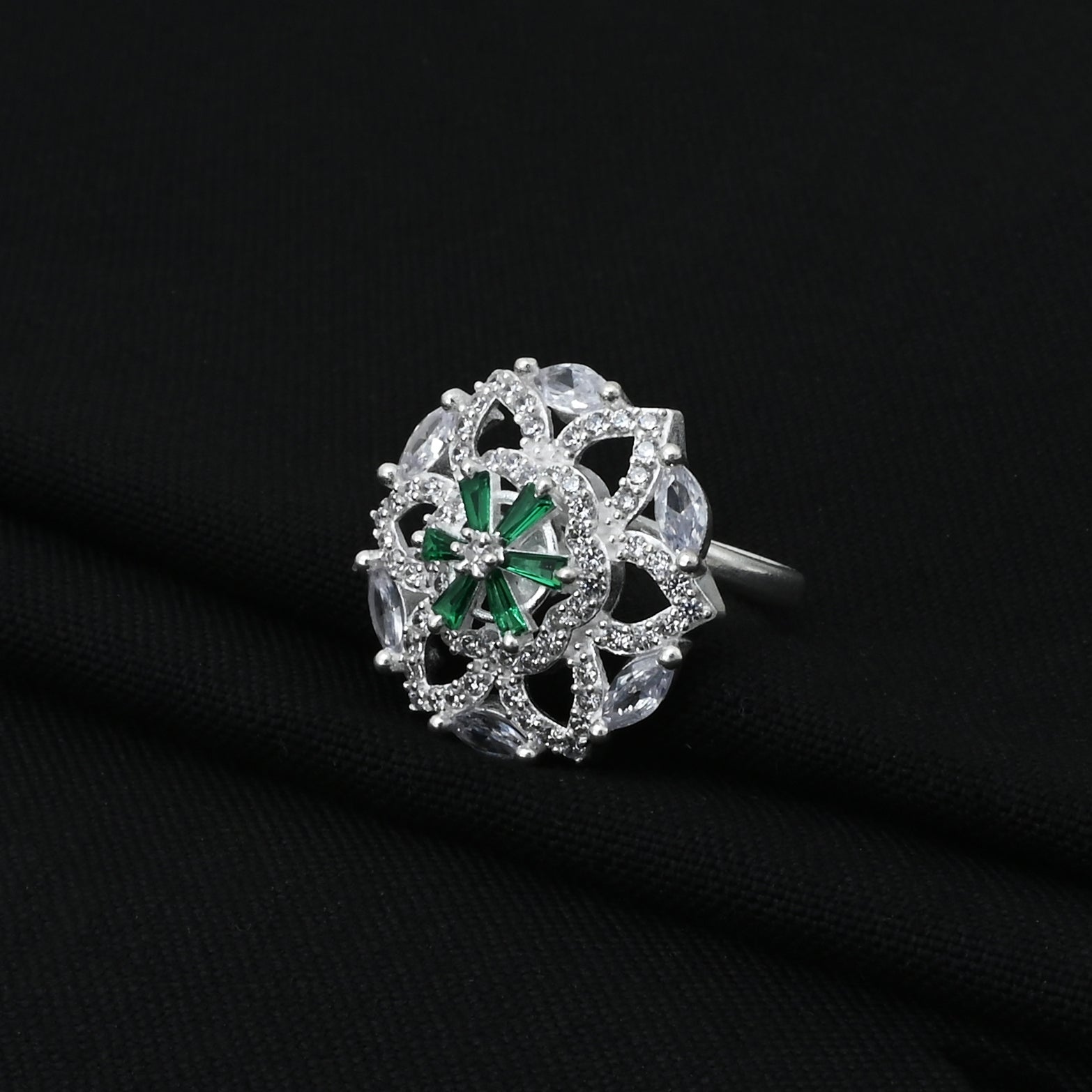 Stylish silver ring with dazzling green and white stones, adding a touch of luxury and charm to any outfit.