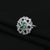 Stylish silver ring with dazzling green and white stones, adding a touch of luxury and charm to any outfit.