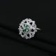 Stylish silver ring with dazzling green and white stones, adding a touch of luxury and charm to any outfit.