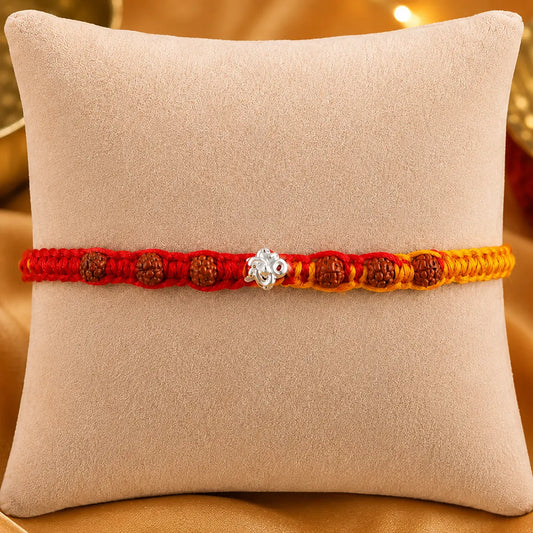 925 Silver Om Rudraksha Rakhi with authentic Rudraksha beads on a beige cushion for Raksha Bandhan gift for brother.