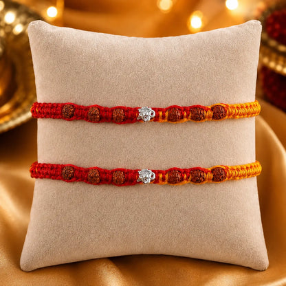 925 Silver Om Rudraksha Rakhi with authentic Rudraksha beads on a beige cushion for Raksha Bandhan gift for brother.