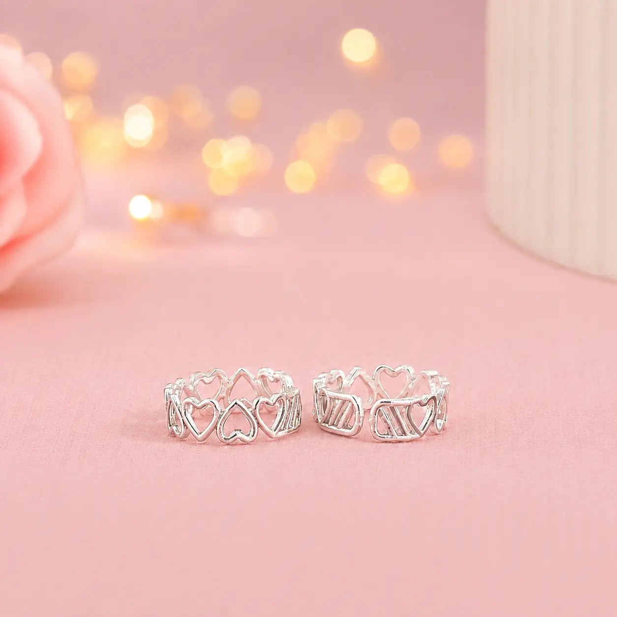 925 Sterling Silver adjustable heart design toe ring pair for women with open heart pattern displayed on a soft pink luxury background